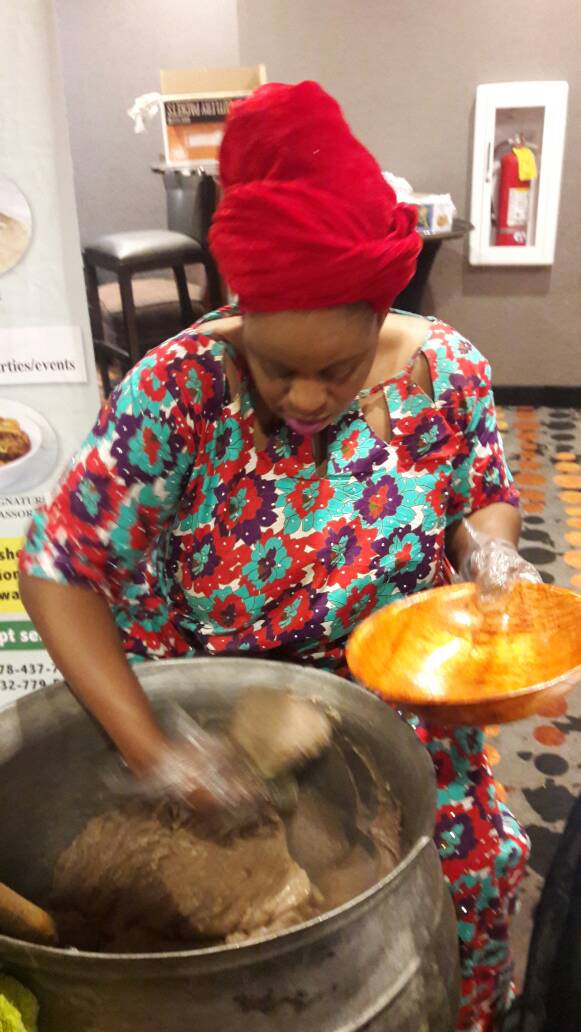 Time to Eat: A woman dishes out hot amala to the ENA members.